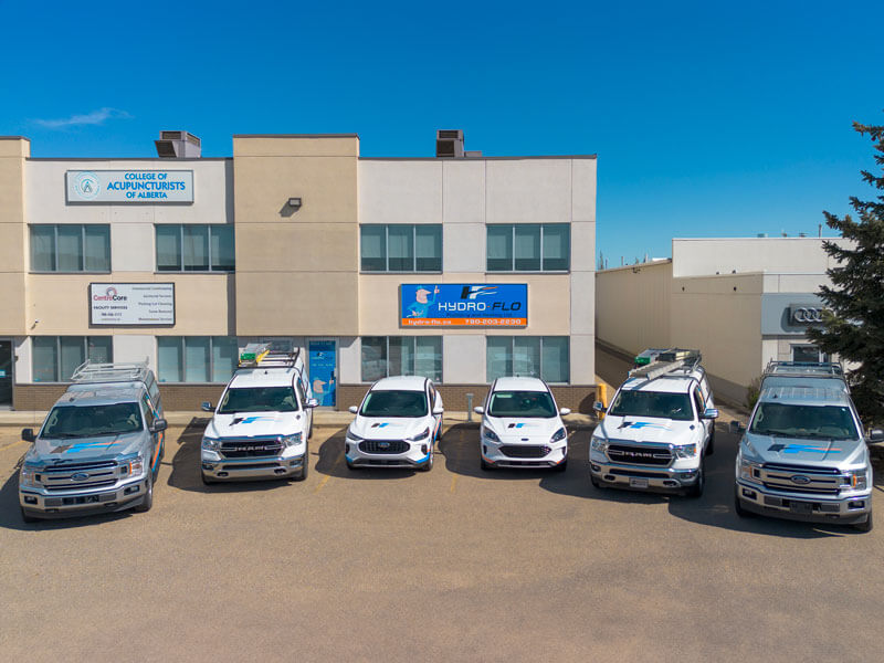 Hydro-Flo trucks parked outside building