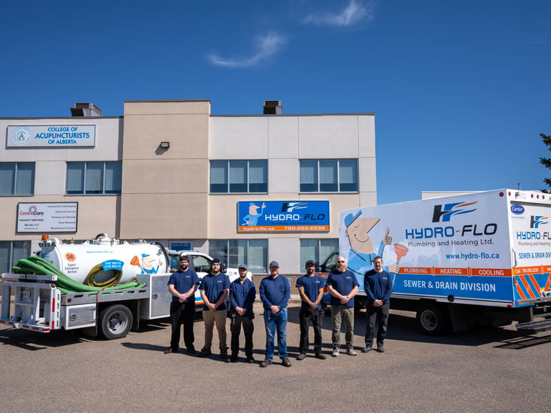 Hydro-Flo workers and trucks outside building